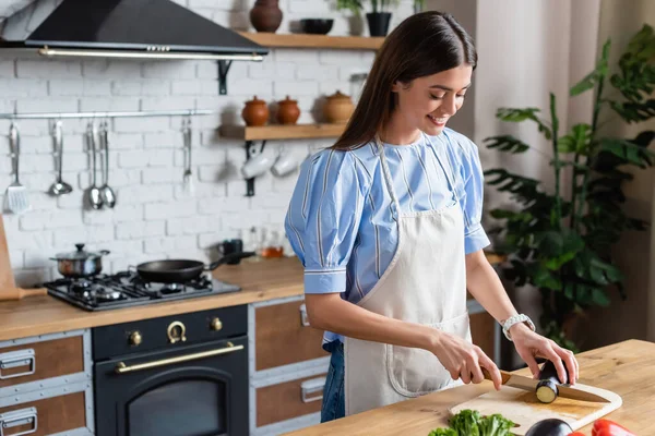 Smiling Young Adult Woman Cutting Eggplant Chopping Board Kitchen — Stock Photo, Image