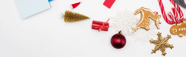 Website header of cookies and candi canes near christmas baubles on white background — Stock Photo