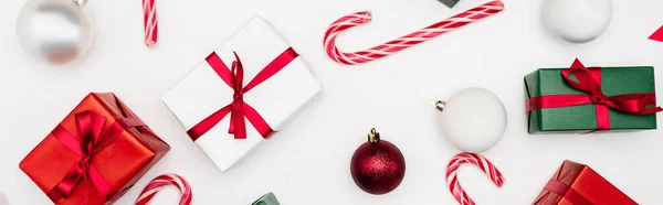 Website header of gift boxes, christmas balls and candy canes on white background — Stock Photo