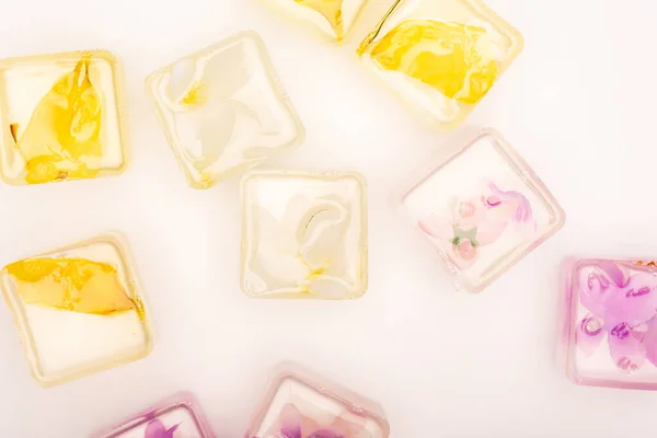 Top view of transparent fruit and vegetable ice cubes on white surface — Stock Photo