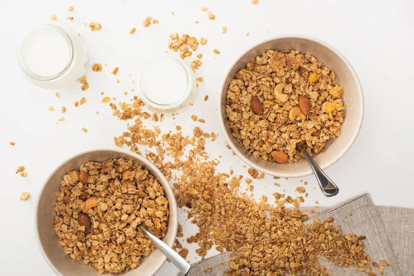 Top view of delicious granola with nuts, yogurt isolated on white — Stock Photo