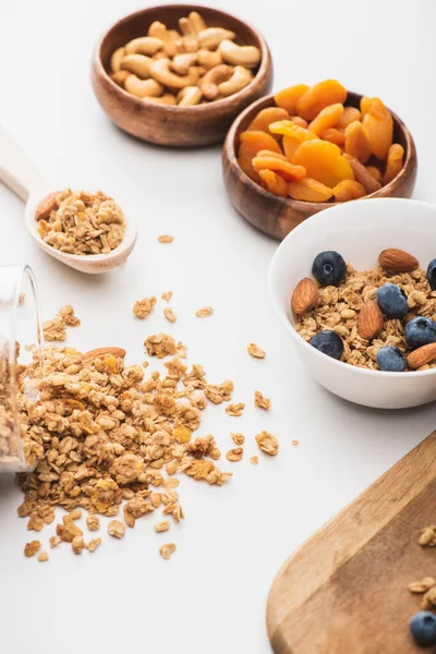 Delicious granola with nuts,dried apricots and blueberry on white background — Stock Photo