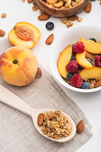 Deliciosa granola com nozes e frutas no fundo branco — Fotografia de Stock