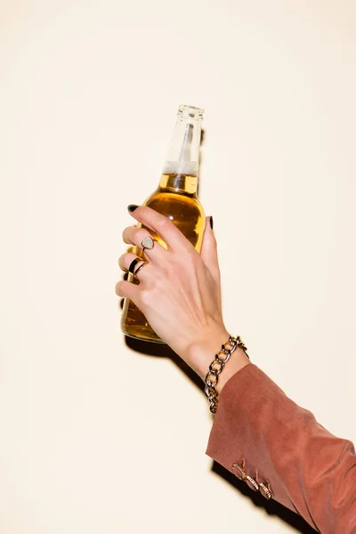 Vista cortada da mulher segurando garrafa com cerveja no branco — Fotografia de Stock