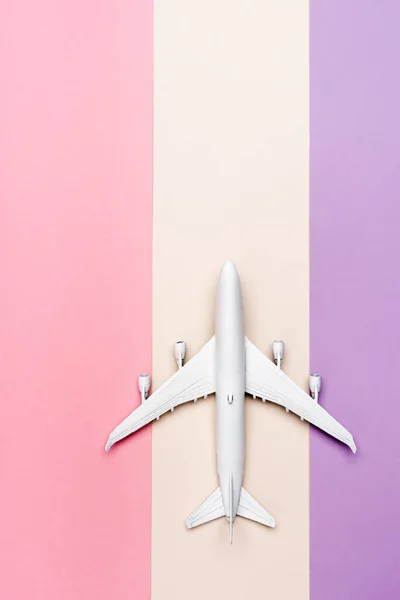 Top view of white plane model on colorful background — Stock Photo