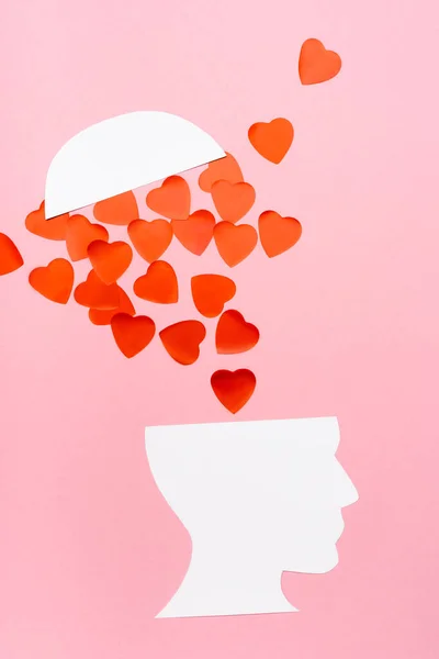 Top view of paper human head and heart on pink background — Stock Photo