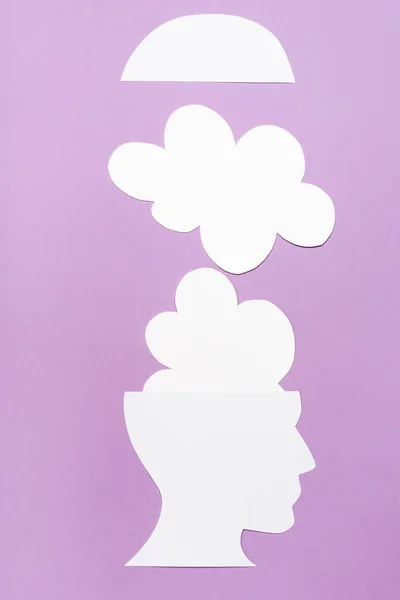 Top view of paper human head and clouds on violet background — Stock Photo