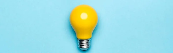Top view yellow light bulb on blue background, banner — Stock Photo