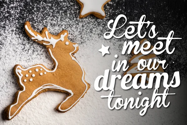 Top view of cookies in shape of deer, pine and star near lets meet in our dreams tonight lettering and sugar powder — Stock Photo