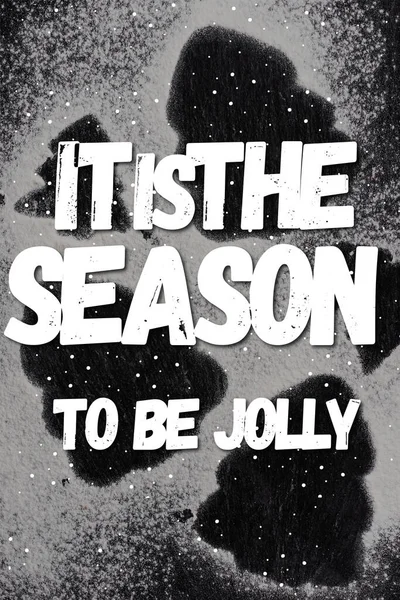 Top view of pine silhouettes covered with sugar powder with it is the season to be jolly lettering — Stock Photo