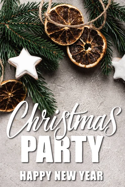 Top view of dried orange slices, cookies and pine branch near christmas party lettering on textured background — Stock Photo