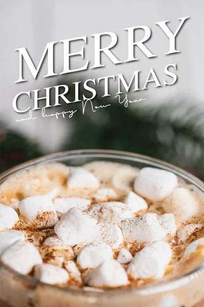 Close up view of glass cup of cocoa with marshmallows and cinnamon near merry christmas and happy new year lettering — Stock Photo
