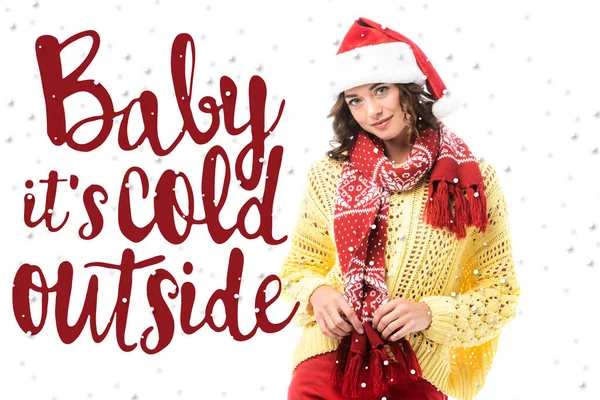 Young brunette woman in santa hat touching red scarf near baby its cold outside lettering on white — Stock Photo