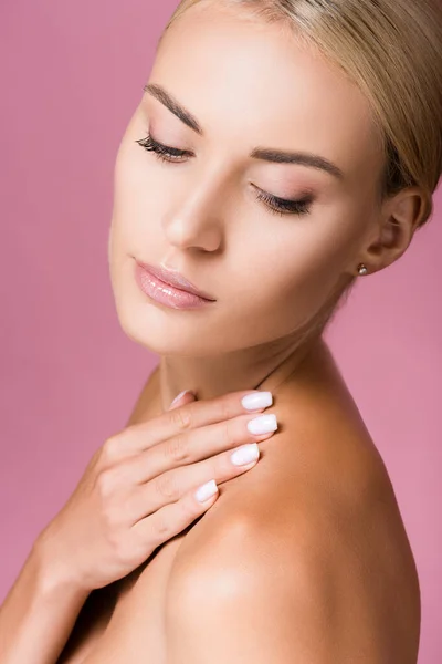 Beautiful blonde woman touching skin isolated on pink — Stock Photo