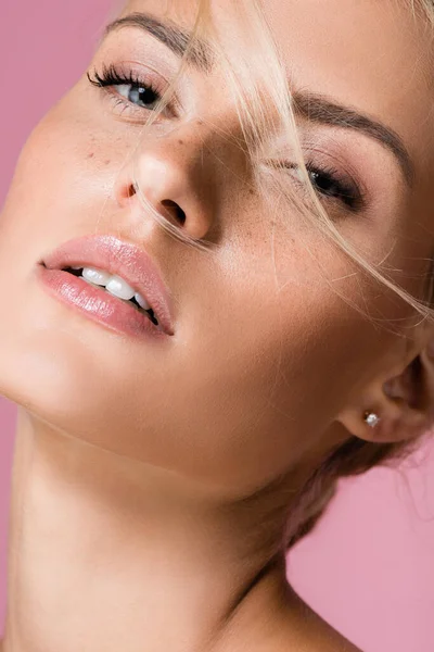 Beautiful blonde woman with freckles isolated on pink — Stock Photo