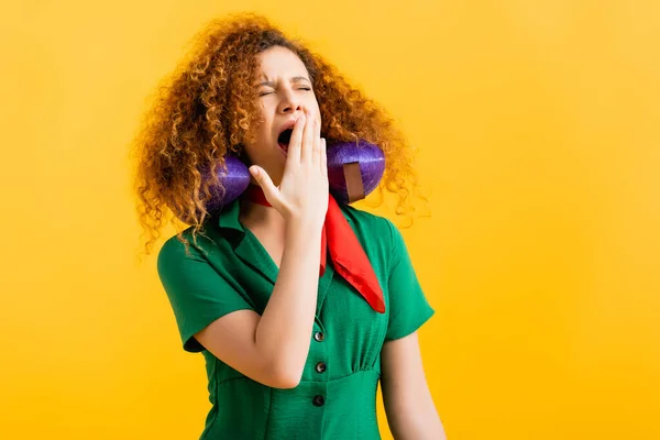 Somnolent avec oreiller de voyage bâillant et couvrant la bouche isolé sur jaune — Photo de stock