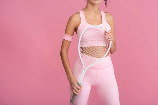 Cropped view of young woman in sportswear holding tennis racket isolated on pink — Stock Photo