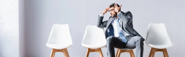 Tired businessman pointing with hands while waiting in hall, banner — Stock Photo