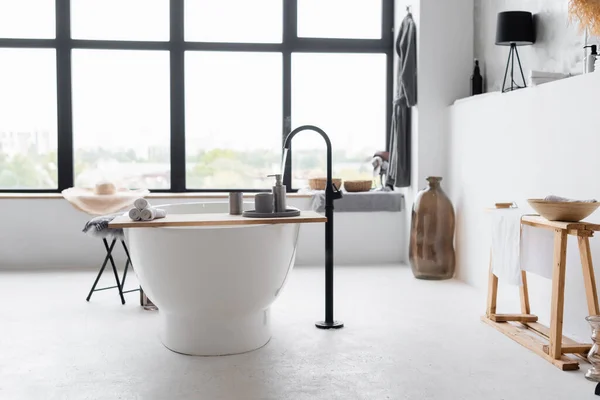 Interior of modern bathroom with bathtub and window — Stock Photo