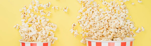 Top view of big and small buckets with crunchy popcorn on yellow, banner, cinema concept — Stock Photo