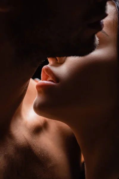 Close up of young woman kissing shirtless boyfriend — Stock Photo