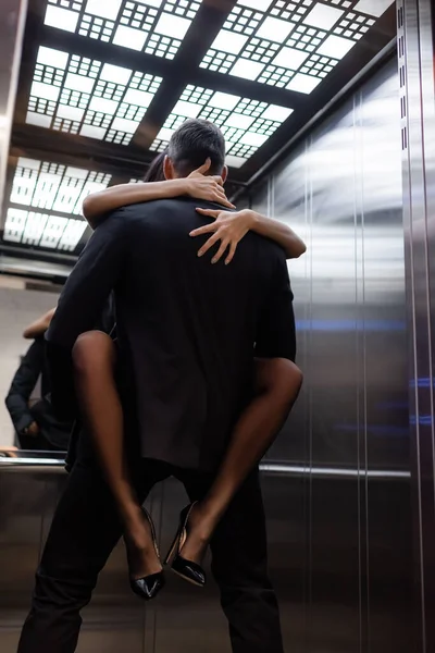 Couple passionné faisant l'amour dans l'ascenseur sur le premier plan flou — Photo de stock