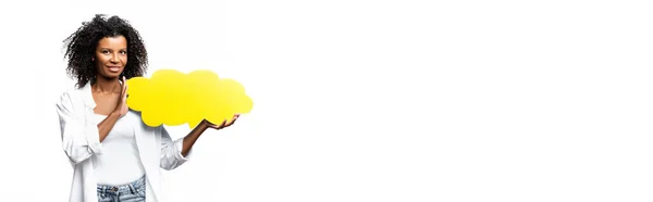 African american woman with yellow speech bubble smiling at camera isolated on white, banner — Stock Photo