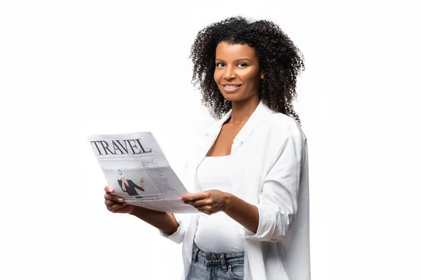 African american woman smiling at camera while holding travel newspaper isolated on white — Stock Photo