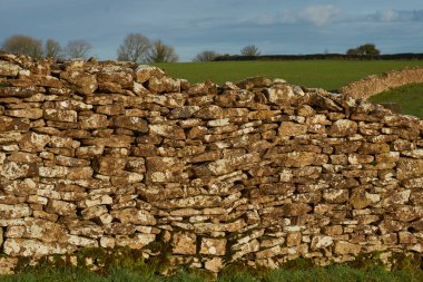 Wolley Vadisi 'ndeki alan sınırlarını belirleyen kuru taş duvarlar, İngiltere, Bath' ın eteklerindeki Cotswolds 'daki Olağanüstü Doğal Güzellik Bölgesi.