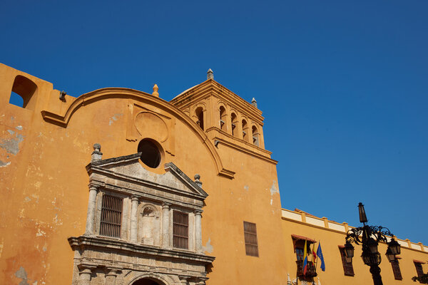 Colourful facade of the historic church, Iglesia De Santo Domingo, in the historic UNESCO World Heritage Site of Cartagena de Indias in Colombia.