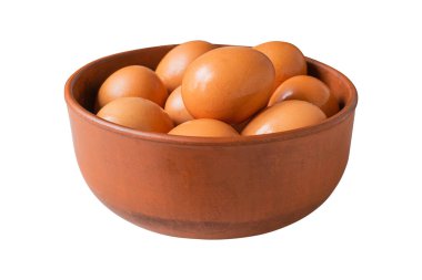 Brown eggs in a clay bowl isolated on white background.