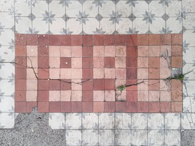 1990 is laid out of ceramic tiles on an old abandoned wall.
