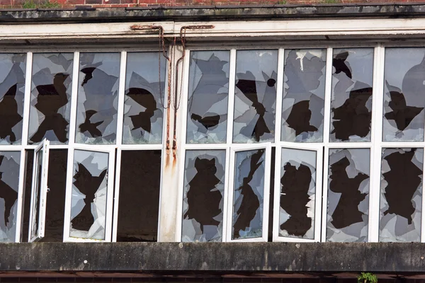 Vandalised glass in a derelict industrial premises — Stock Photo, Image