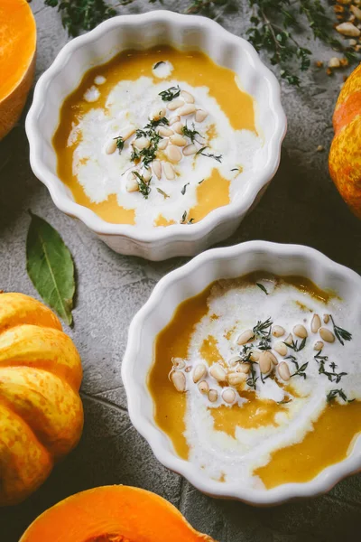 Pumpkin soup, On a gray background with pumpkins, Autumn atmosphere, Top view, Selective focus