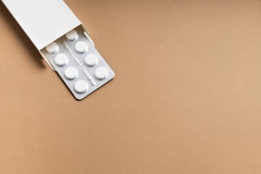 Renkli arka planda beyaz hapların ambalajı