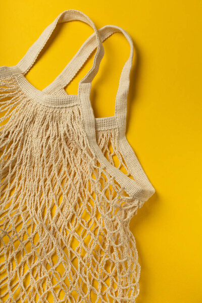 Eco-friendly bag on yellow background