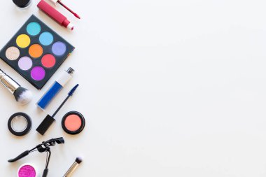 Bright multi-colored decorative cosmetics on a light background