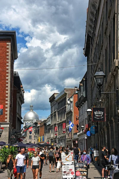 stock image Montreal, Canada - July 31, 2021: Crowd of people walk along the street Rue Saint-Paul E in old Montreal during the long weekend. 