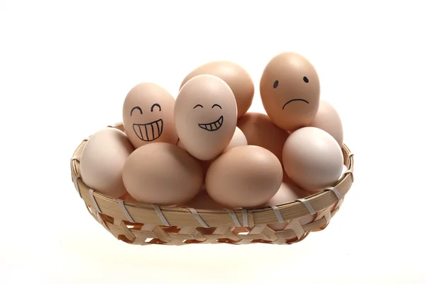 Eggs in bamboo basket with smile faces — Stock Photo, Image