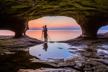 Sea Cave Photographer at Sundown clipart