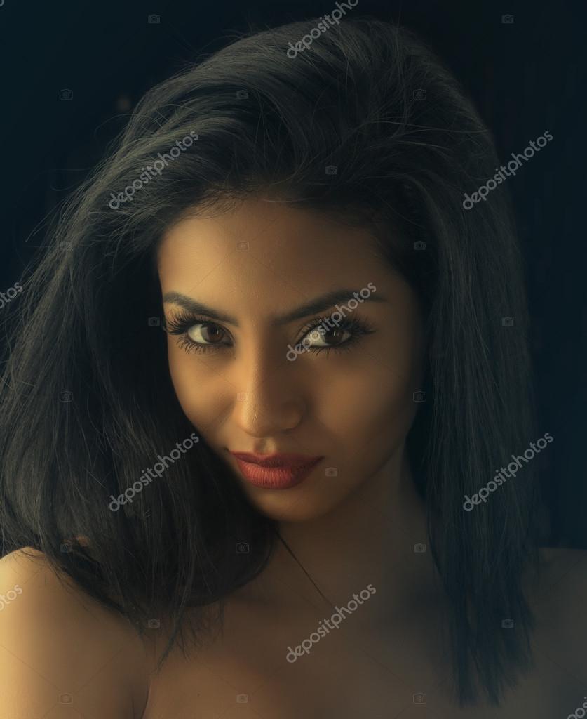 Beautiful Exotic Young Woman With Friendly Welcoming Smile Stock Photo