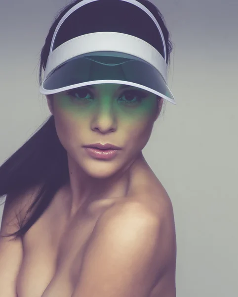 Beautiful woman wearing sun visor — Stock Photo, Image