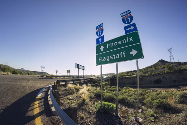 I17 Road sign for Phoenix and Flagstaff, Arizona - options - choice - Fish eye super wide angle view — Stock Photo, Image
