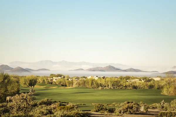 Golf course with dramatic unusual low lying fog in distant Pheonix,Az,USA — Stock Photo, Image