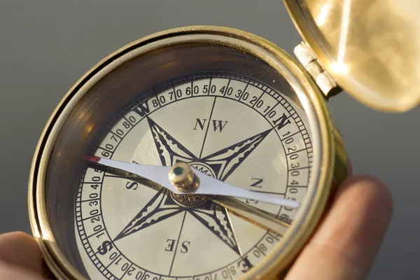 Man holding compass for direction — Stock Photo, Image