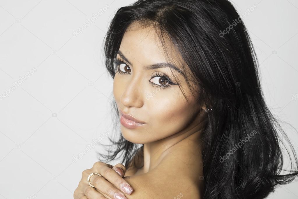 Beautiful exotic young woman face and bare shoulder