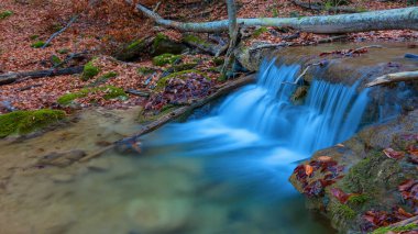 beautiful small waterfall on a mountain river, autumn mountain canyon natural landscape