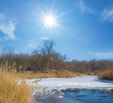winter frozen river under a sparkle sun, winter outdoor scene