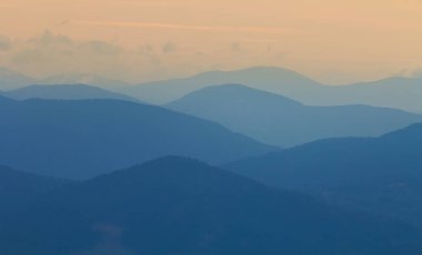 mountain chain silhouette in blue mist, natural mountain background