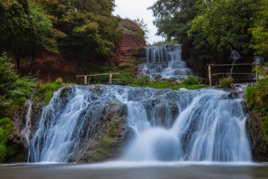 closeup big blue waterfall in mountain canyon